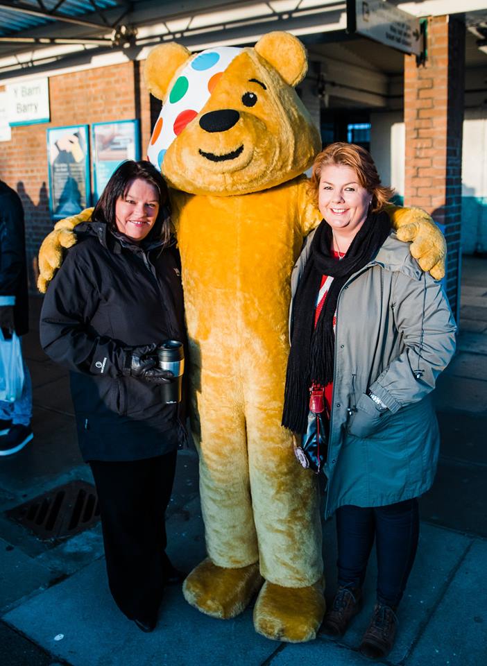 Pudsey Bear take a photo with more two women.