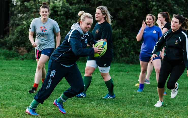 kevin moore photographer captures team members of the barry ladies rfc Incoming tackle