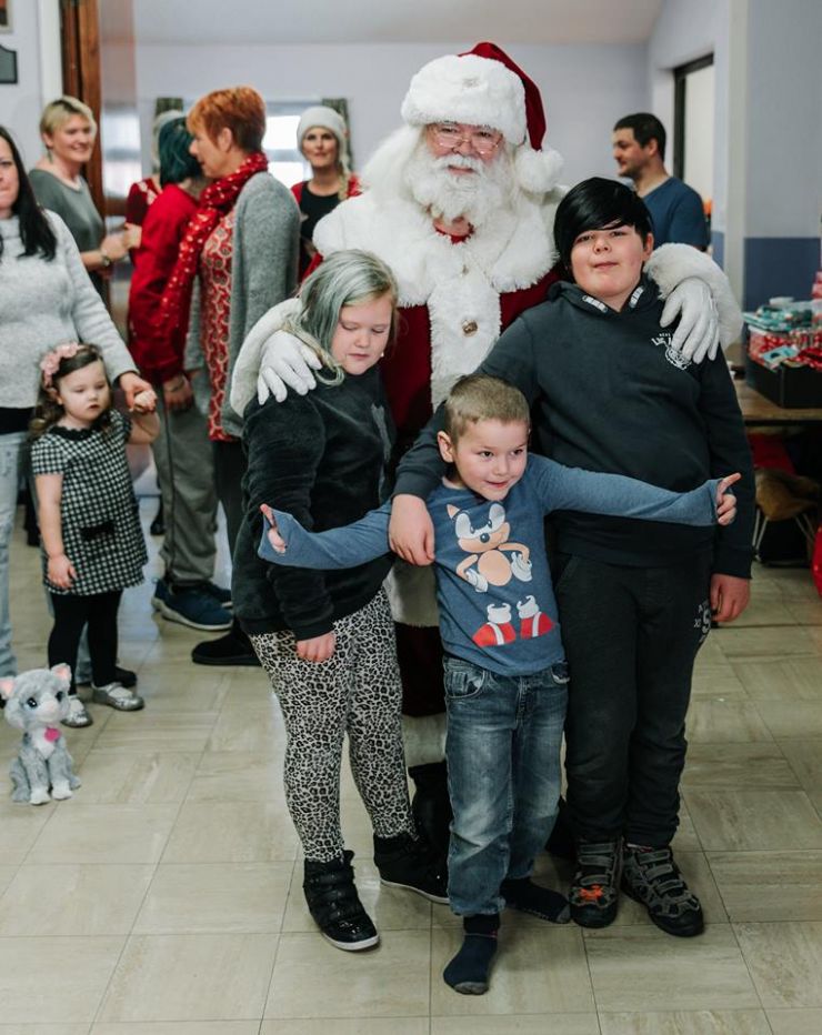 Childrens take a photo with Santa Claus.