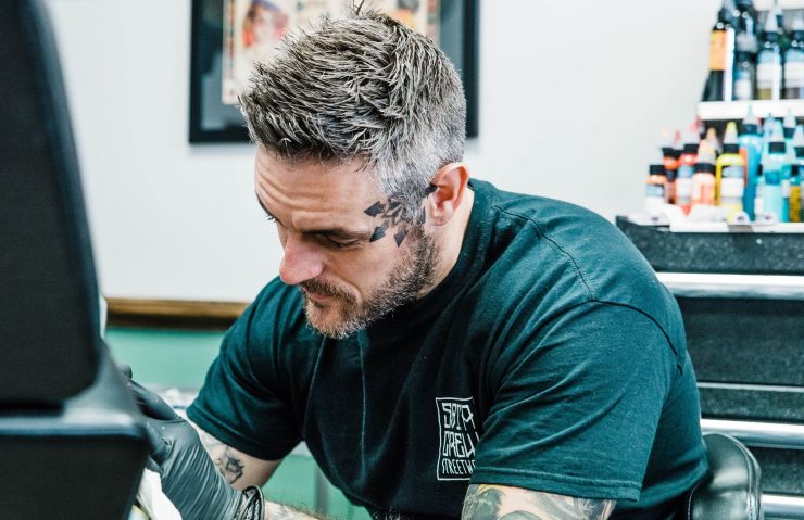 kevin moore photographer takes a close up of tattoo artist lee john clements