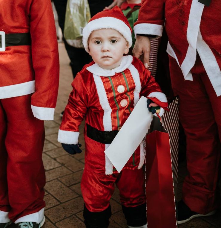 Child dress like a Santa Claus.