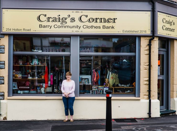 kevin moore photogrpaher captures bette sim outside her charity shop called craigs corner