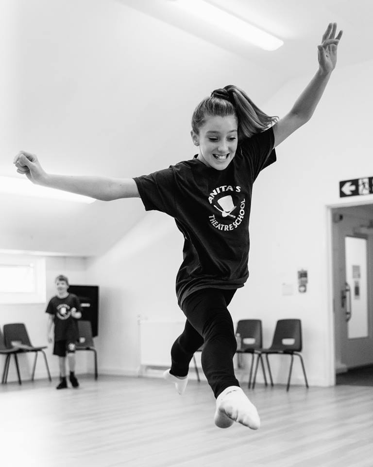 Girl trying to take a dance step.