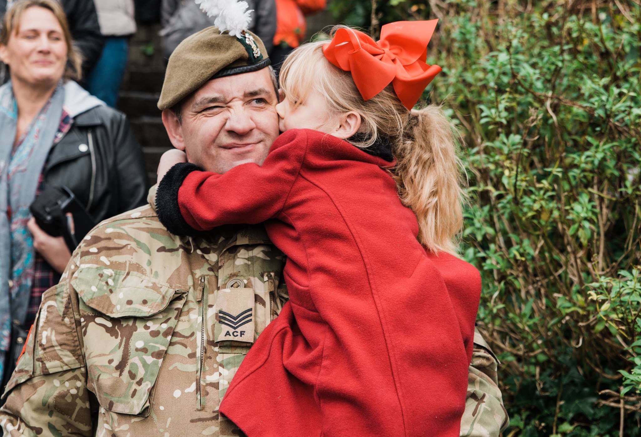 Child kisses a man.