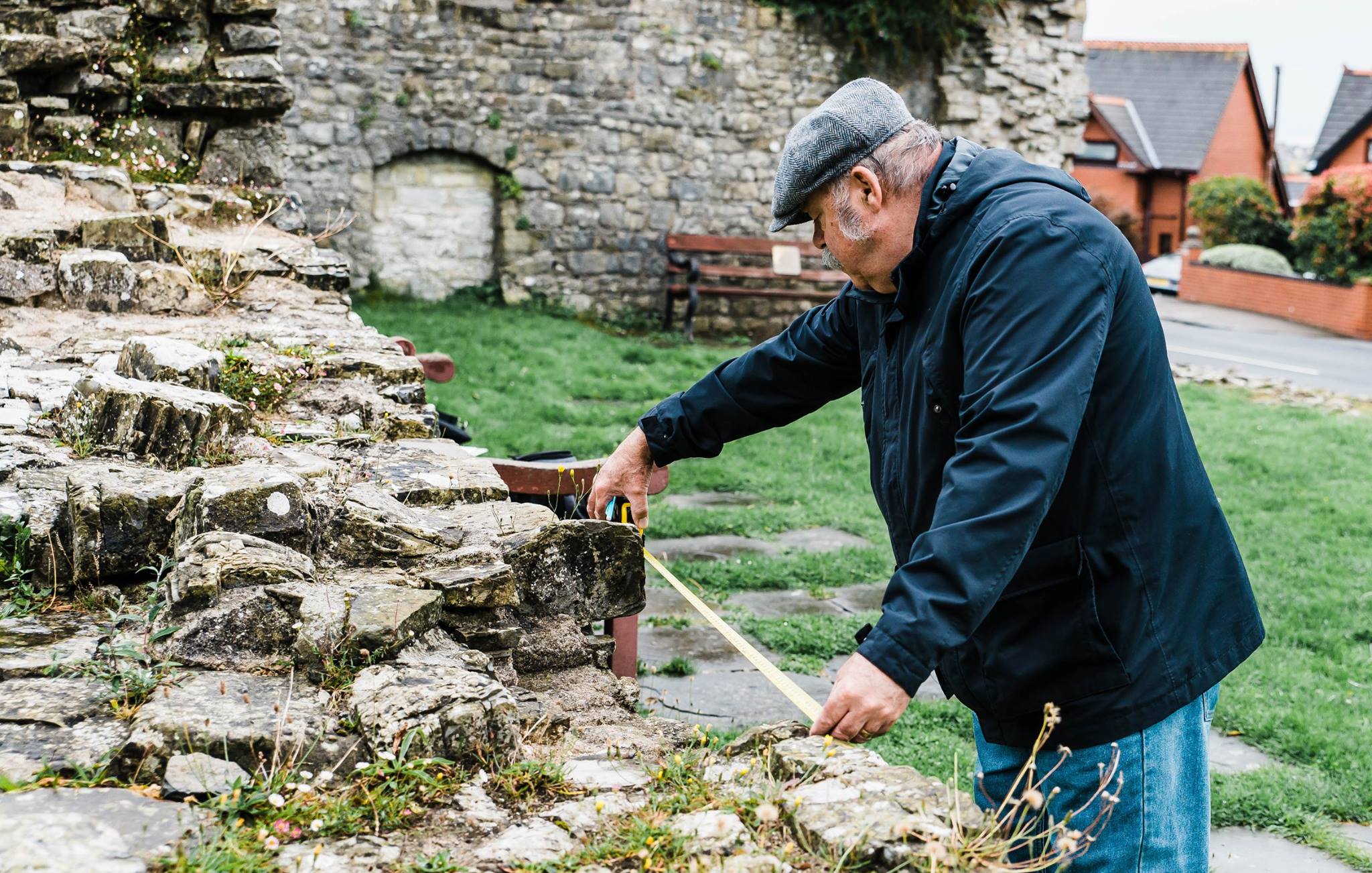 kevin moore photographer captures archaeologist gareth tyley measuring to make a model to on display