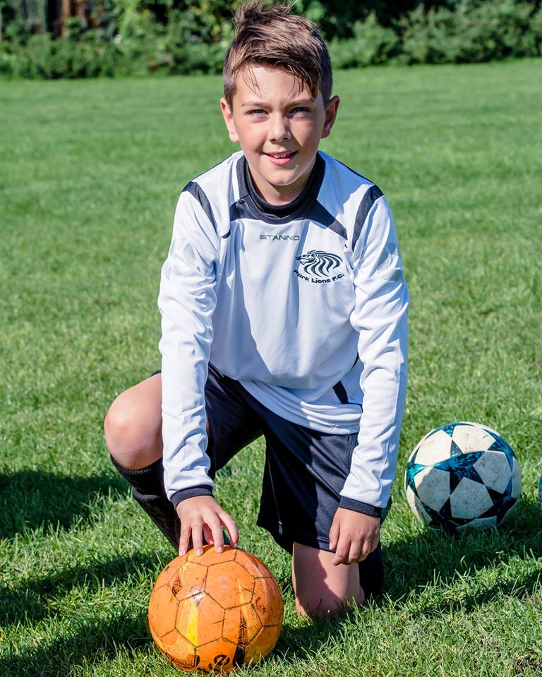 Kid player smiling at the camera.