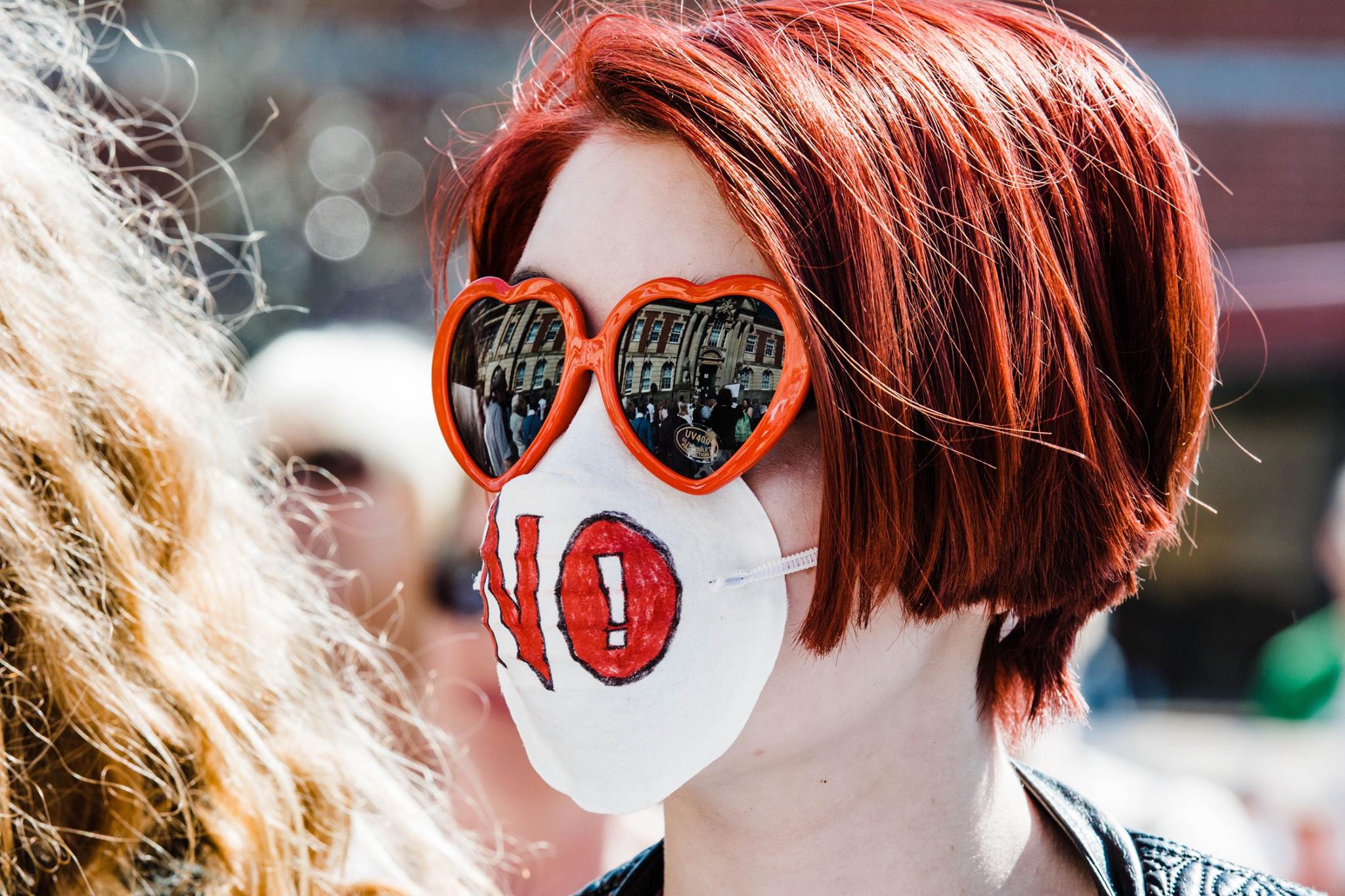 kevin moore photographer captures the public protesting against the aviva biomass incinerator, a young woman with mask