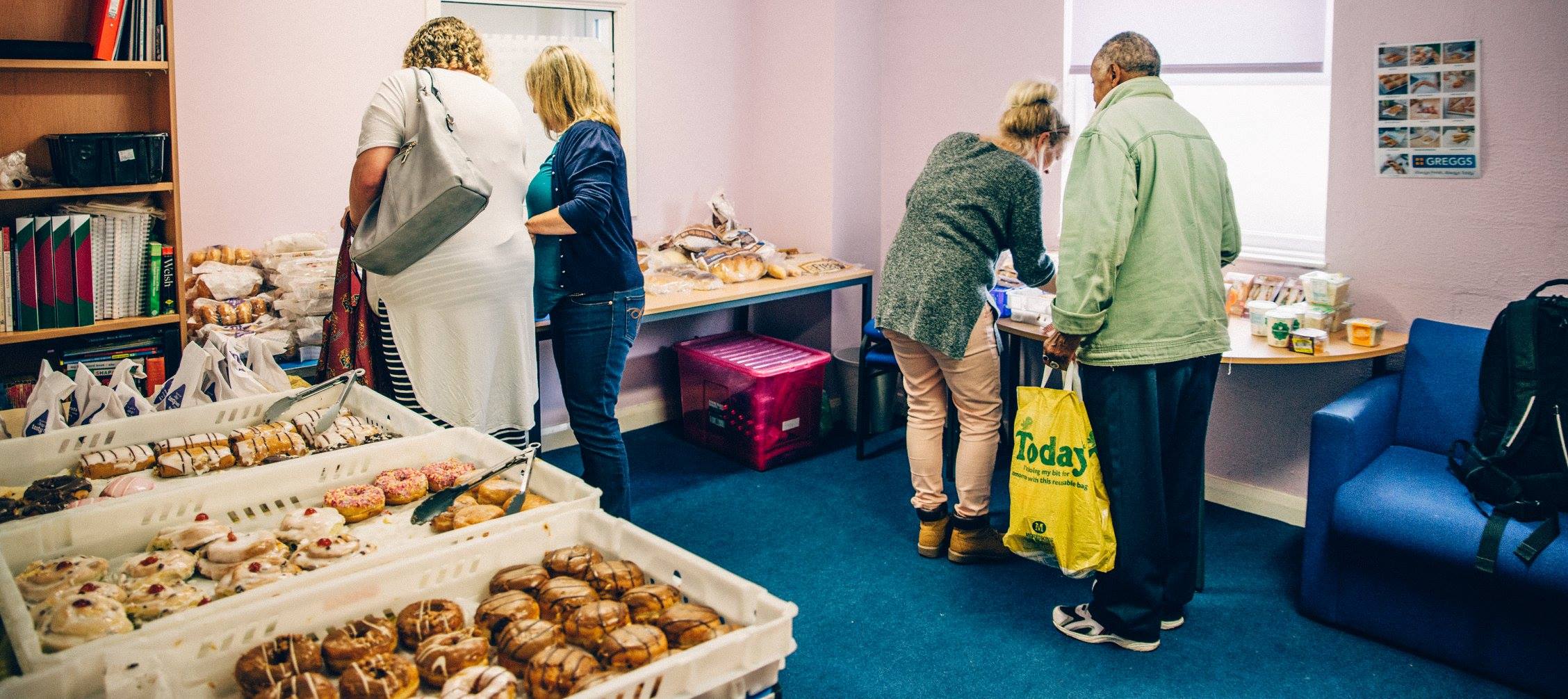 People staff giving food for people who need it.