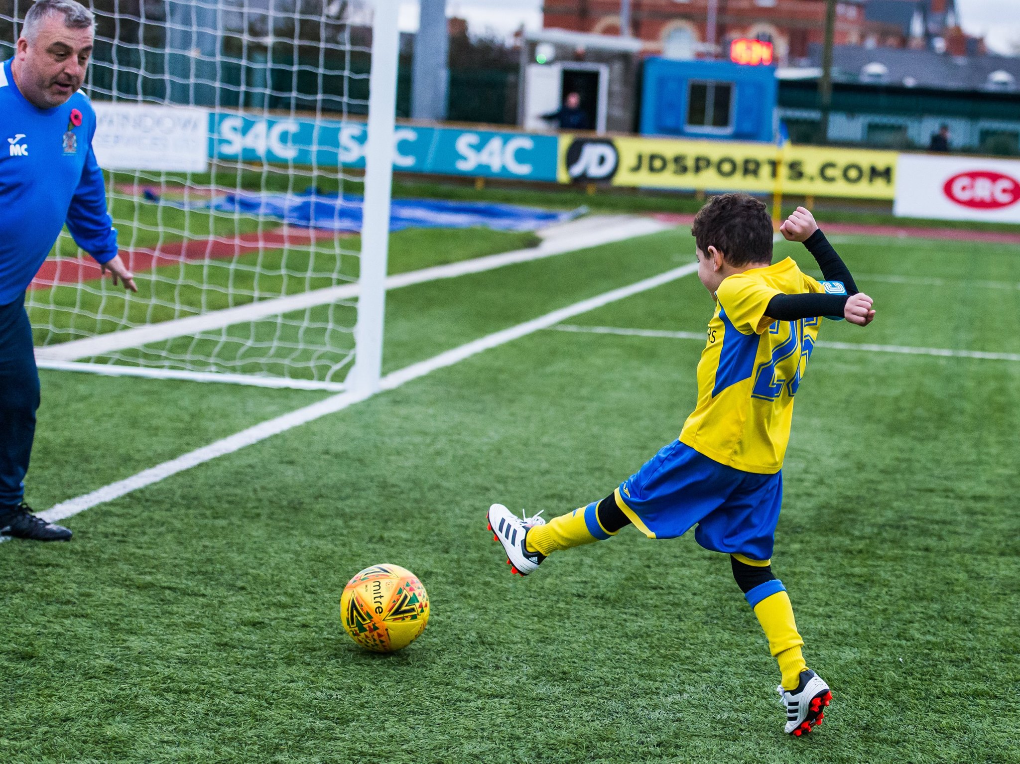 A little player shoots the ball.