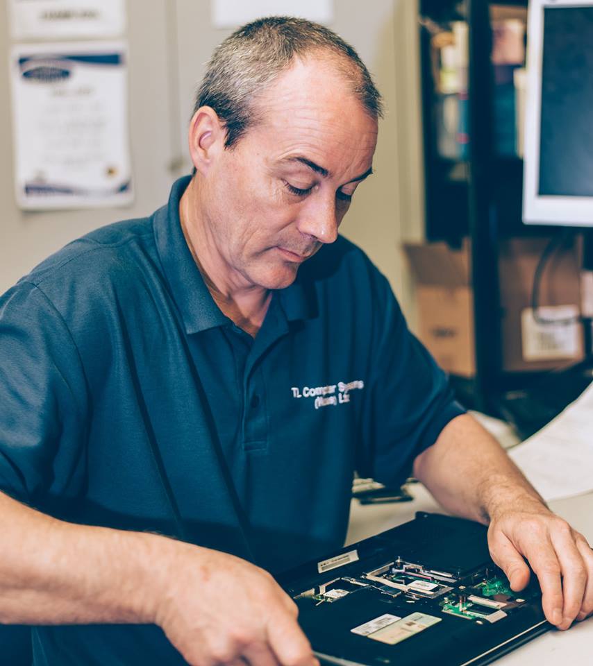 Dave Elliott fixing a computer.