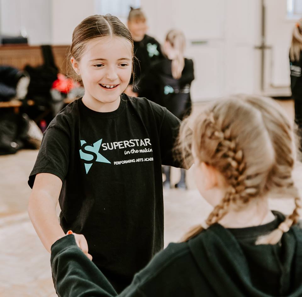 Two girls dancing together.